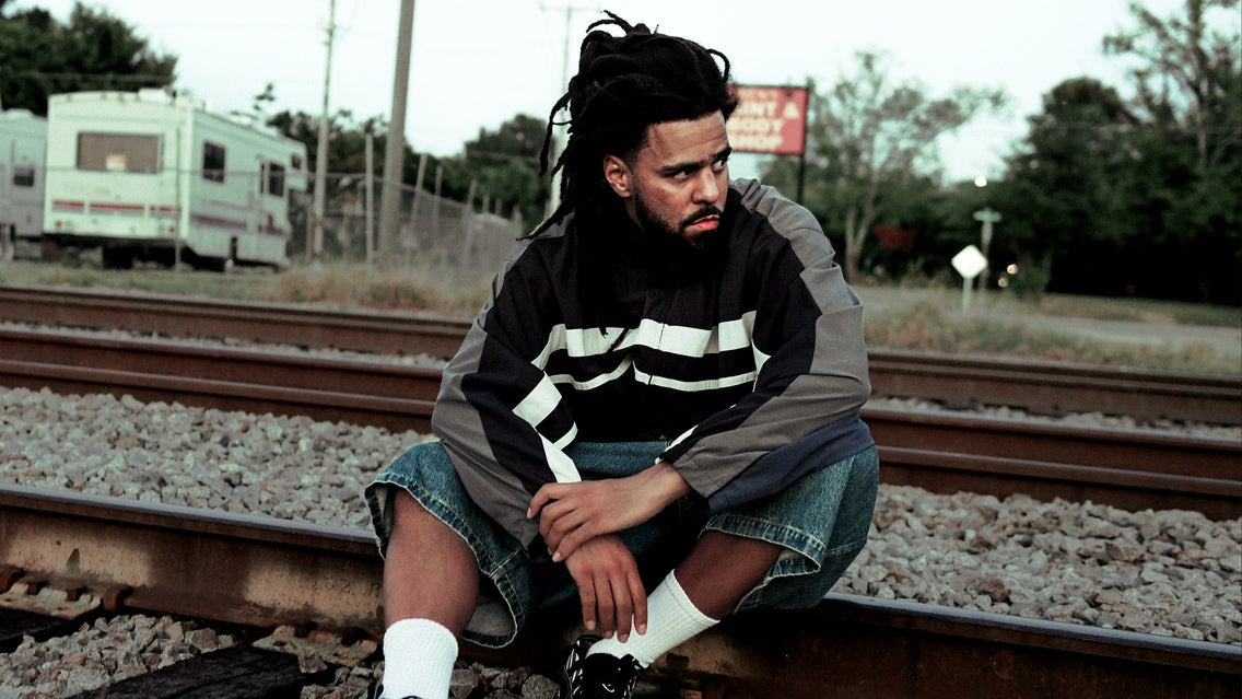 J. Cole by railway tracks